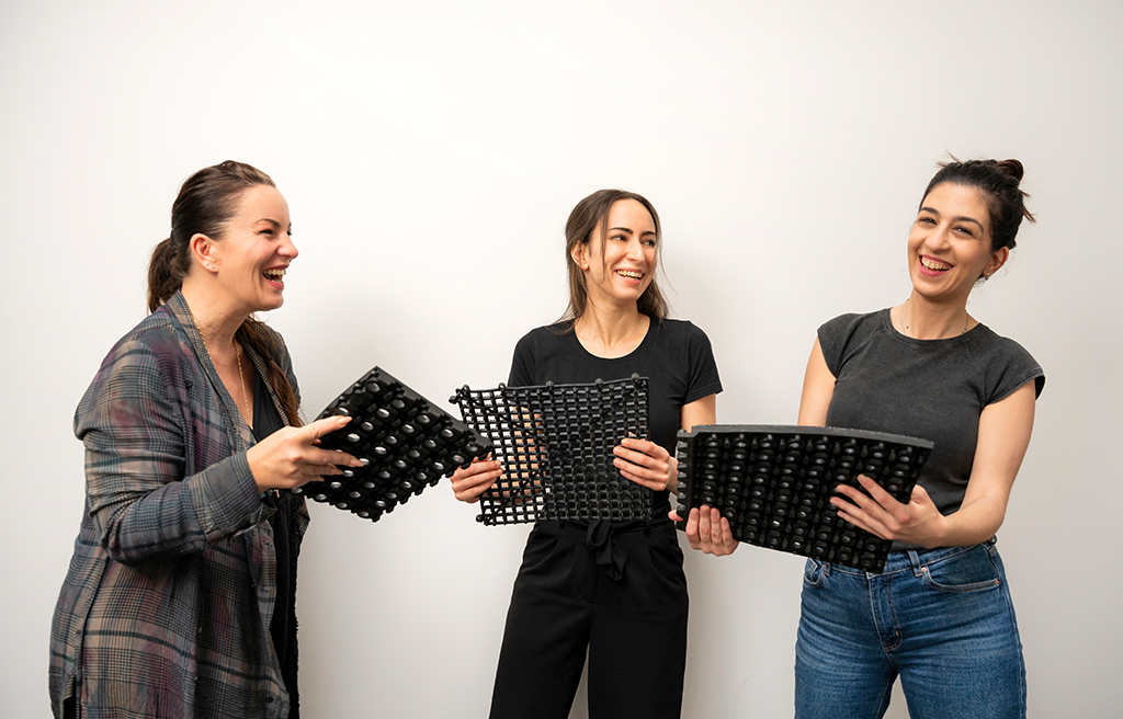 COBA team happy holding mat samples