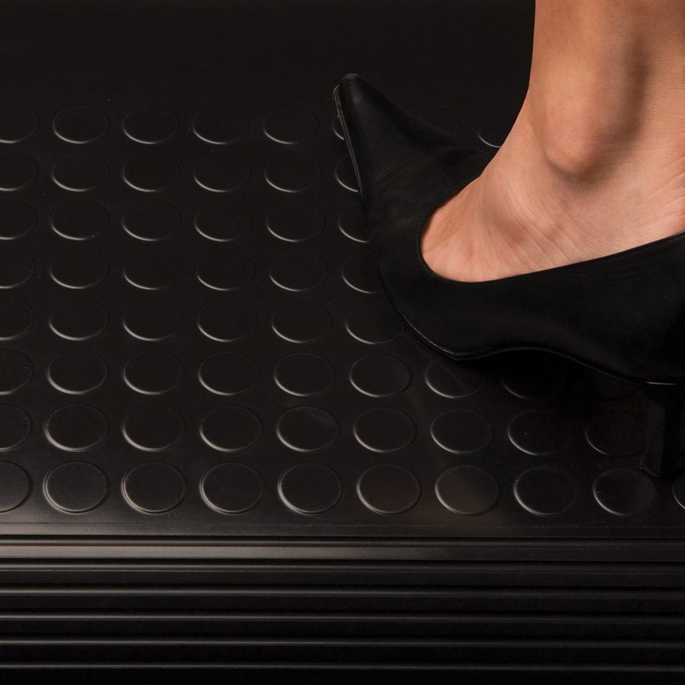 Person-standing-in-heeled-shoes-on-a- black-rubber-COBAdot-vinyl-mat