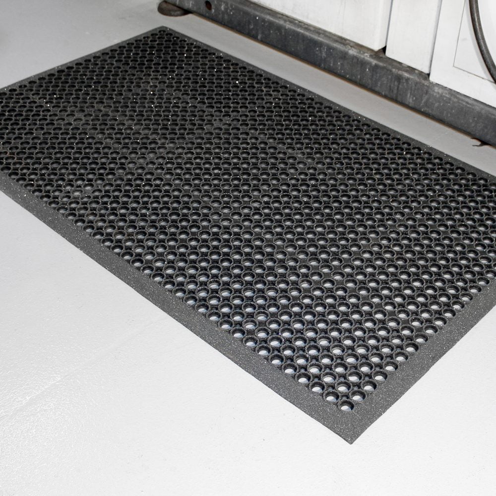 Close-up-image-of-a-rubber-high-duty- grit-anti-slip-mat-beside-a- workstation