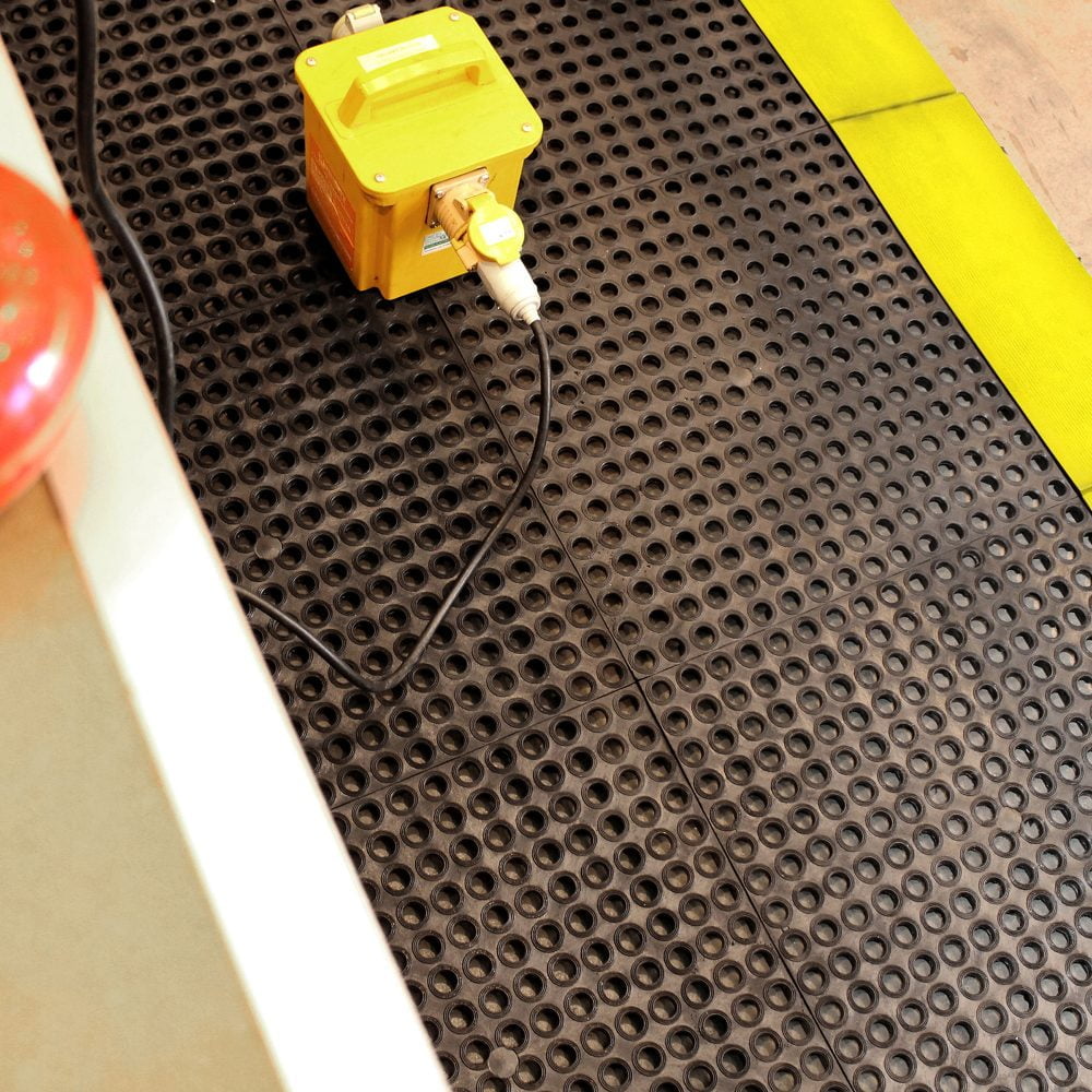 Electricity-cables-running-over-a- holed-black-anti-slip-toughdeck-mat