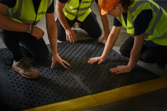 Team installing COBA interlocking anti-fatigue mats