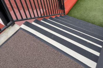 Padel Now staircase with COBA Gripfoot Conformable tape overlooking the padel courts.